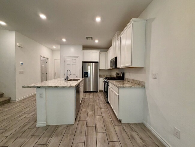 Building Photo - GATED 3 BED 2.5 BATH TOWNHOME WITH 2-CAR GARAGE, COVERED PATIO & COMMUNITY POOL