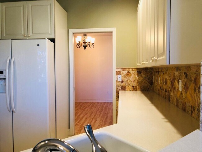 Building Photo - Experience Bell Tower Park. GATED ground floor 2 Bed 2 Bath Den 1 Car Garage Condo.