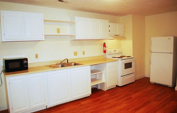 View of the kitchen taken from hall to living room. Fridge is in alcove to the right. - 1728 I St