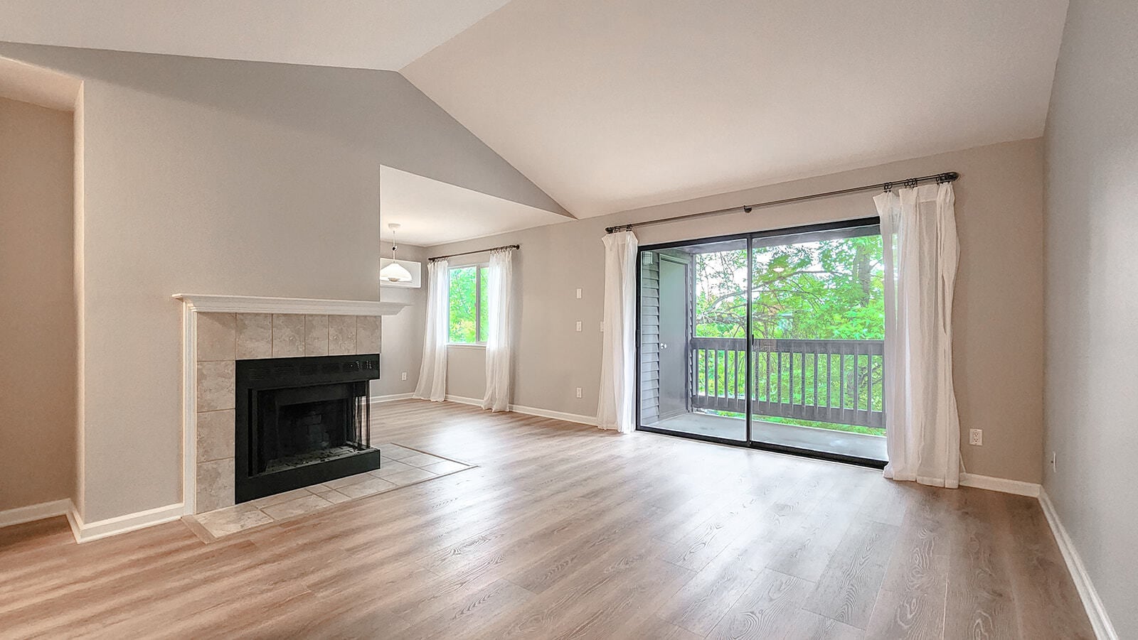 Open living room with double glass doors to private balcony - 9580 SW 146th Ter