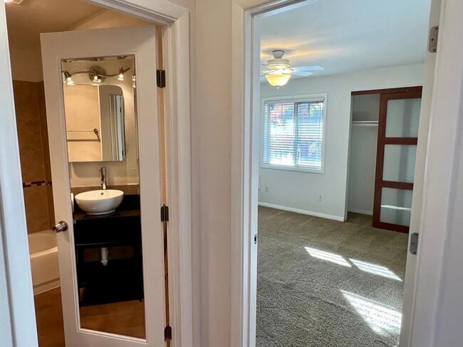 bathroom and primary bedroom - 4956 NE 9th Ave