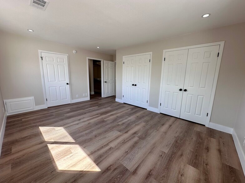 Primary bedroom with walk in closet and full bathroom - 770 W 2nd St