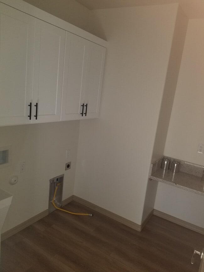 Laundry room with hookups for gas and electric. - 5180 N Roadrunner Dr