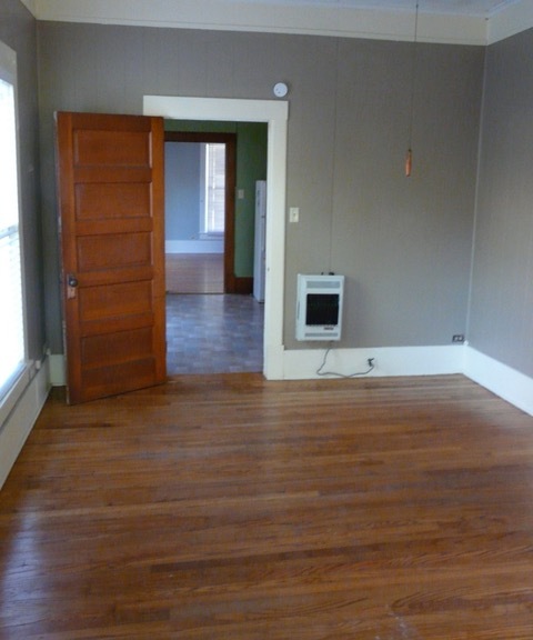 View into kitchen and living room from bedroom - 615 W Oak St