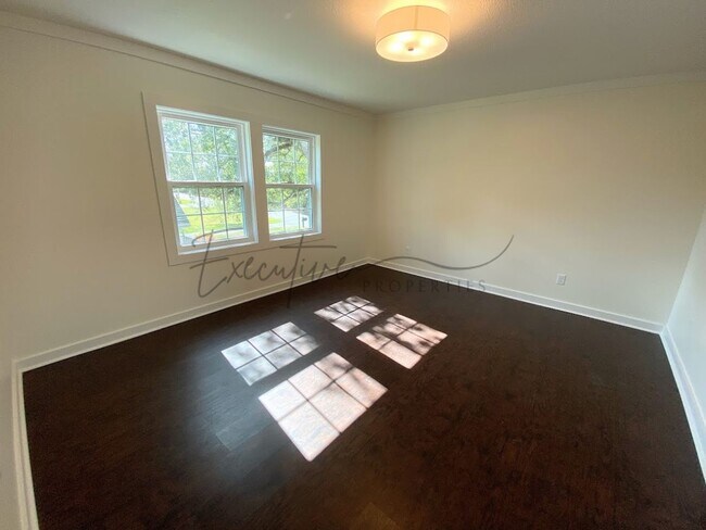 Building Photo - Spacious 4-Bedroom with Custom Finishes in...