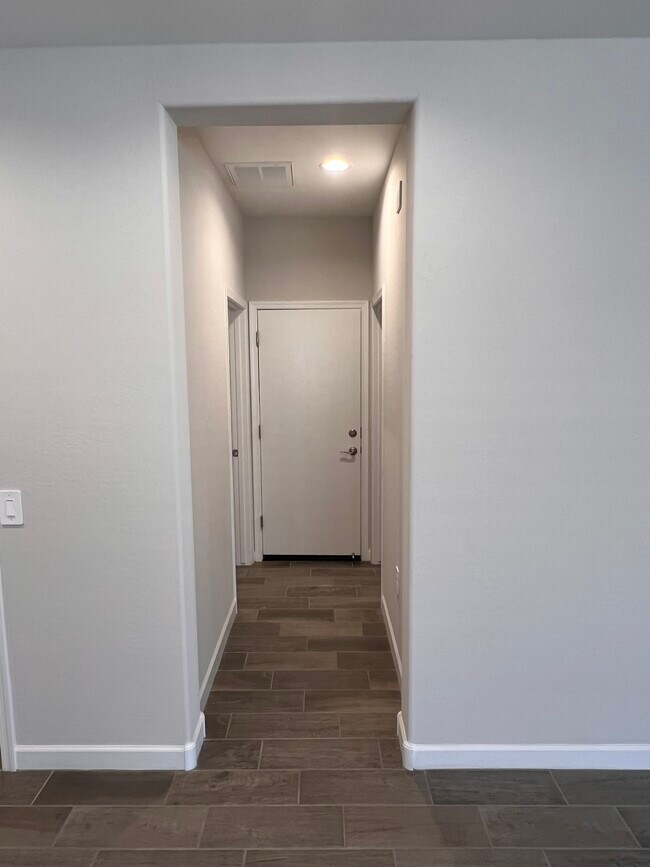 Hall to laundry, garage and 1/2 bath - 37640 W San Sisto Ave