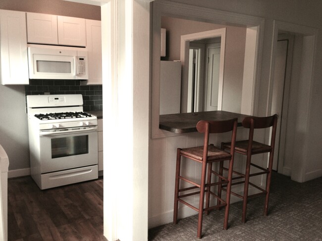 dining room view of the bar & kitchen with all appliances. - 4104 Dover St