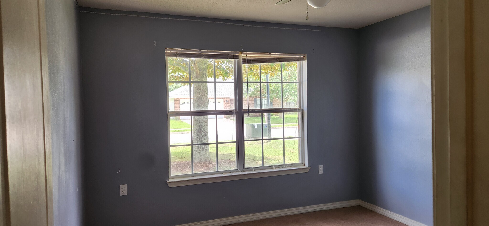 Bedroom 3 with a closet and a double window view of the front yard - 2318 Tall Oak Dr