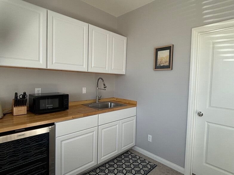 wall cabinets, microwave, and sink with disposal - 32914 Guinness Way