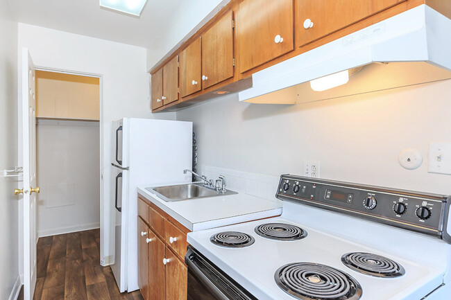 Royal Gardens - Kitchen featuring white appliances, large Formica counter tops, and tan cabinets. - Royal Gardens