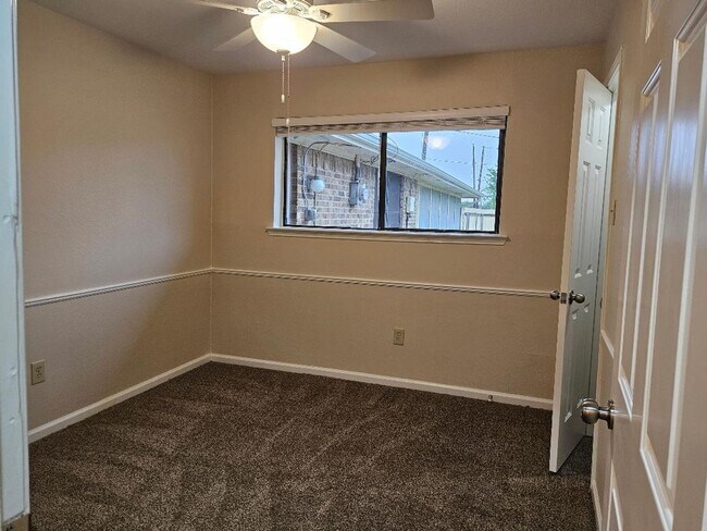 Building Photo - Three bedroom and two bathroom nicely remodeled with new flooring. Large wood fenced backyard