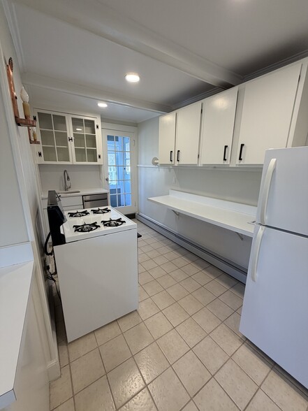 Eat in kitchen with gas stove, new dishwasher~ back door leads to screened in porch and large deck - 19 Irving St