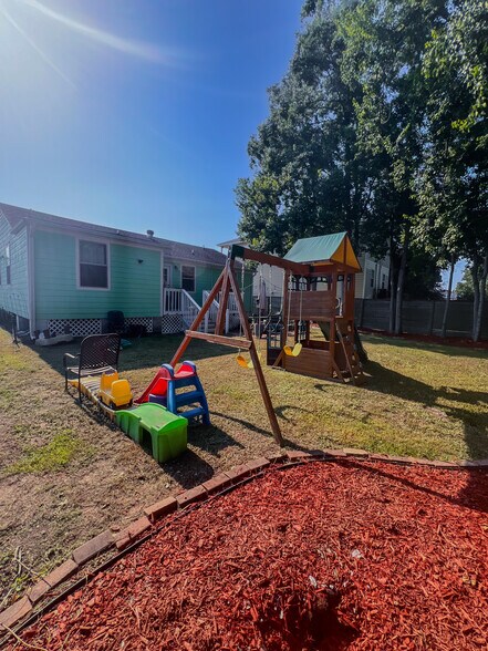 Massive landscaped backyard with playground, trees, patio, deck - 5717 Pasteur Blvd