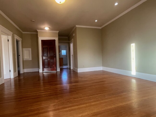 A view of the entrance, with the bathroom door to the right, and the kitchen past that. - 286 19th Ave