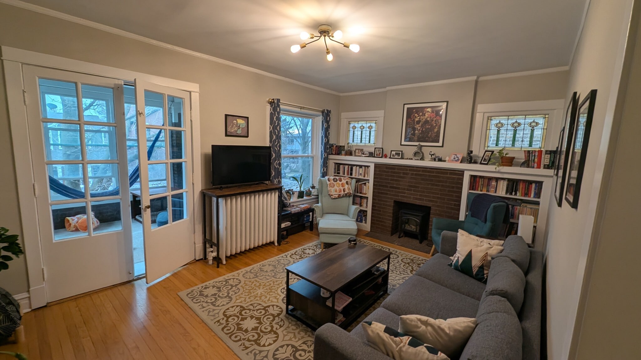 Living room with sunporch and large window and stained glass - 2176 W Windsor Ave