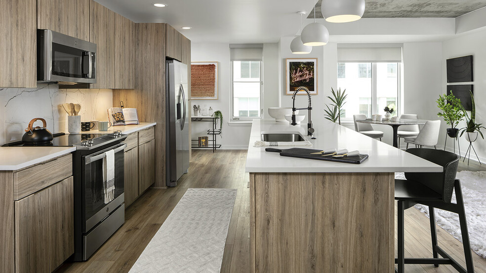 Apartment Kitchen with Stainless Steel Appliances, Dining Room and with wood floors. - Griffis LoDo