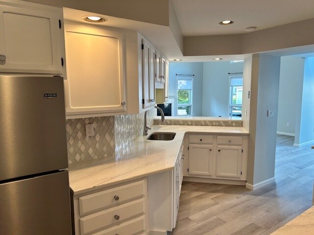 Kitchen with new quartz countertops and refrigerator - 42 Pepper Ln