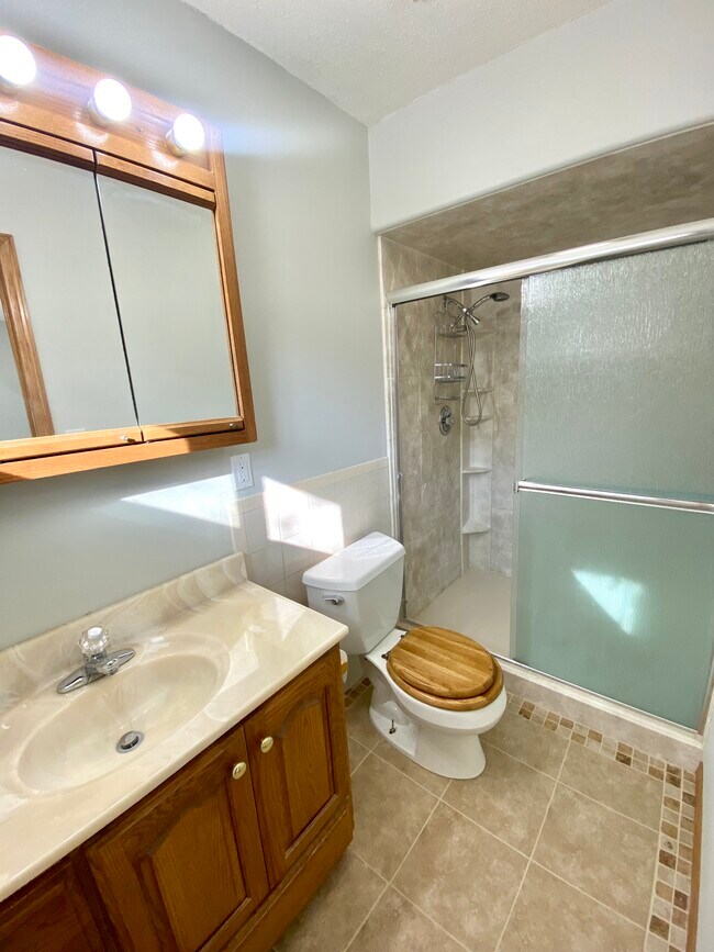 Main floor: An en suite bathroom in the master bed. - 12821 Westwood Ln