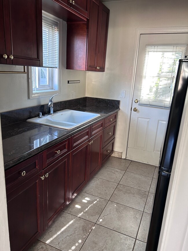 Kitchen with cherry cabinets and granite counters - 5549 Costello Ave