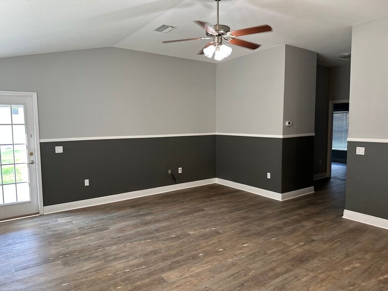 Living room with beautiful laminate floors and ceiling fan - 10727 Standing Stone Dr