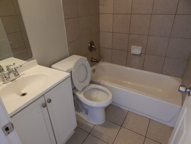 Building Photo - Freshly painted and new flooring in this 4 Bedroom 2 and Half Bath home. Covered front porch with...
