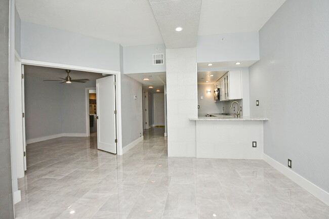 LR looking back toward entrance and kitchen. On left are doors for bedroom - 400 E Colonial Dr