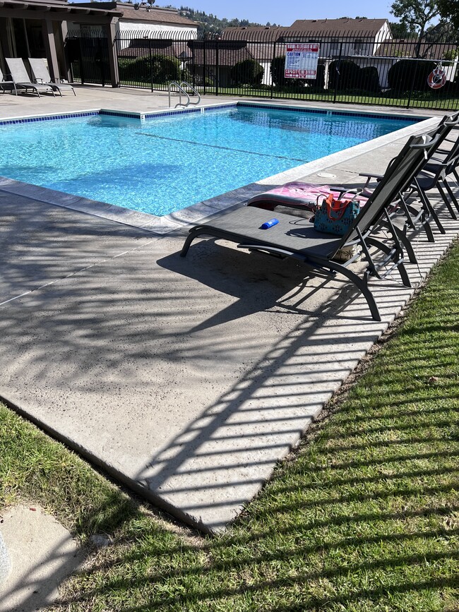 Tropical resort pool with chairs and lounge chairs - 2356 Canyon Park Dr