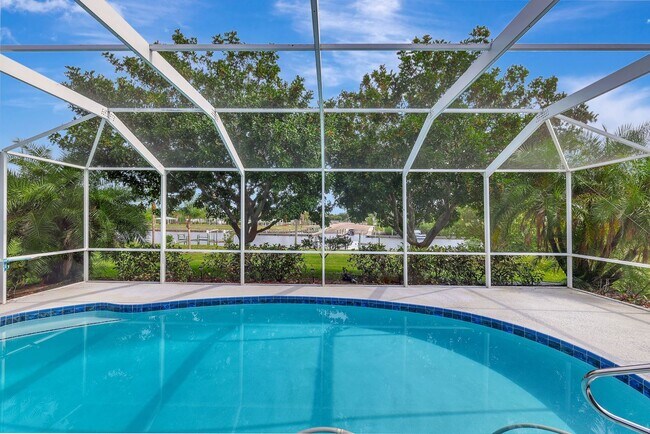 Building Photo - A BOATER'S PARADISE WITH THIS STUNNING 3 BEDROOM, 2 BATH WATERFRONT POOL HOME W/DOCK & BOAT LIFT ...