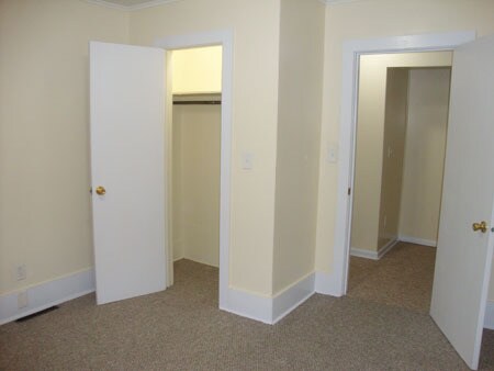 Smaller bedroom, closet on left. Doorway to hall and steps on right. - 522 E Market St