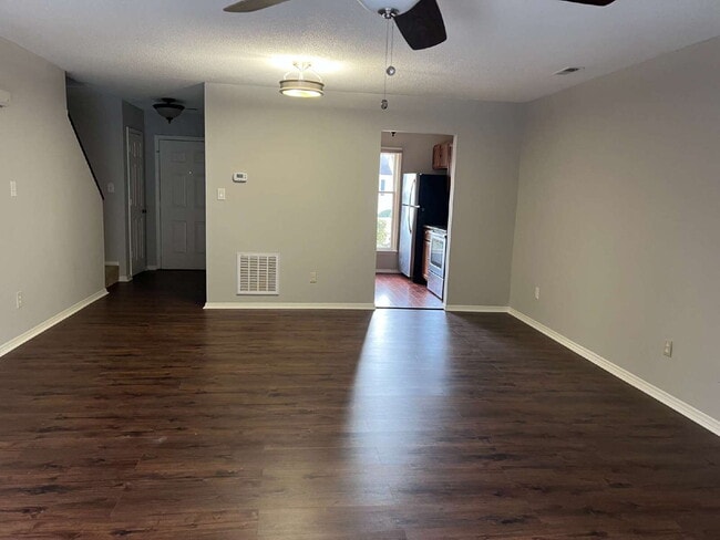 Building Photo - Charming 3 bedroom 2 bath townhome with lots of light and open downstairs. Galley kitchen, lots o...