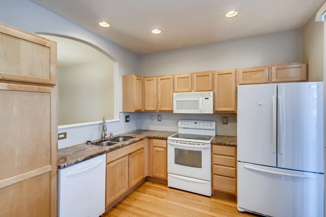Building Photo - Stunning 3-bed 3-bath townhome that features hardwood floors and an attached 2-car garage!