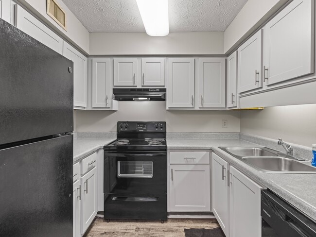 Our Montgomery apartments at Stratford Village feature kitchens with bright white cabinetry and all appliances included, professionally operated by Highlands Vista Group. - Stratford Village