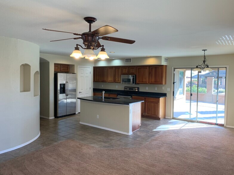 Spacious 4-bedroom, 2-bath home with soaring ceilings, gourmet kitchen, and a heated self-cleaning p - 16426 N 152nd Ln