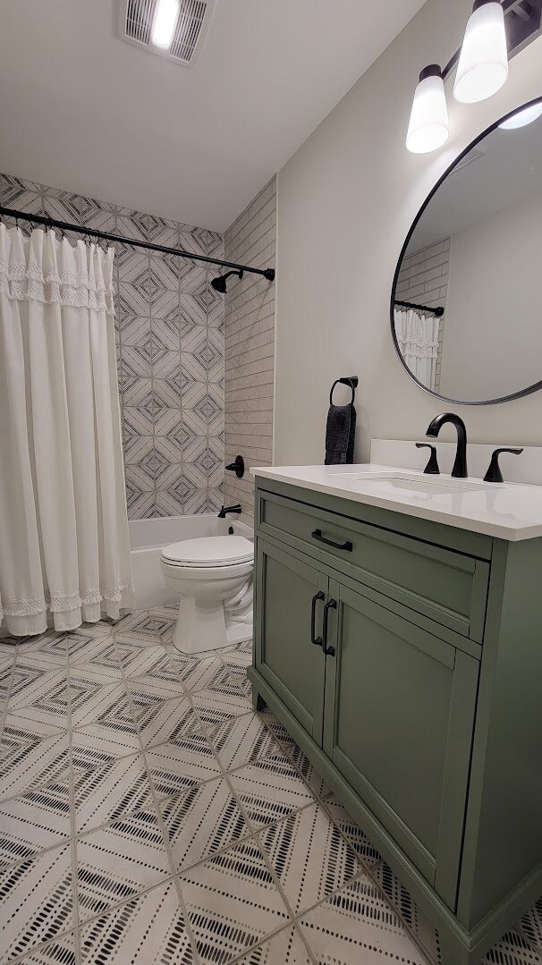 Main bathroom includes all new tile, tile tub surround, Kohler tub & Toilet, New Vanity and Faucets - 6305 49th Ave
