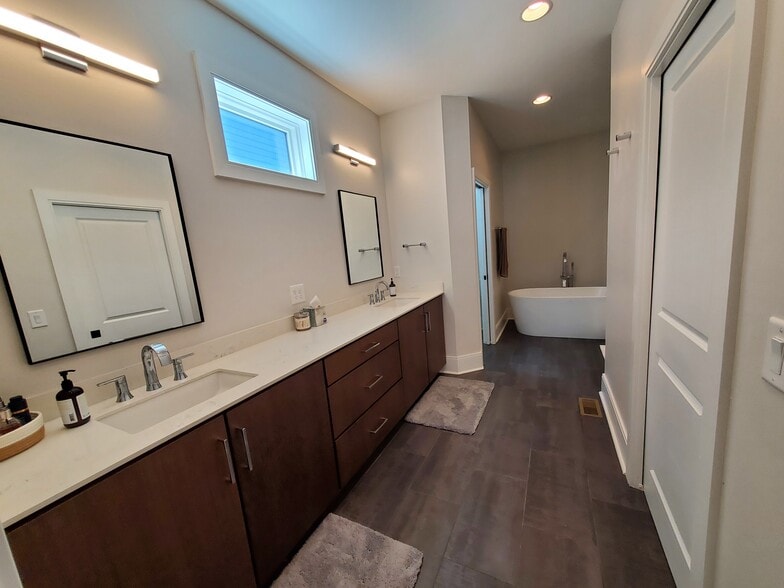 Master bath is a relaxing oasis with spacious double vanity, large walk-in closet, tub and shower. - 1021 Cheatham Pl