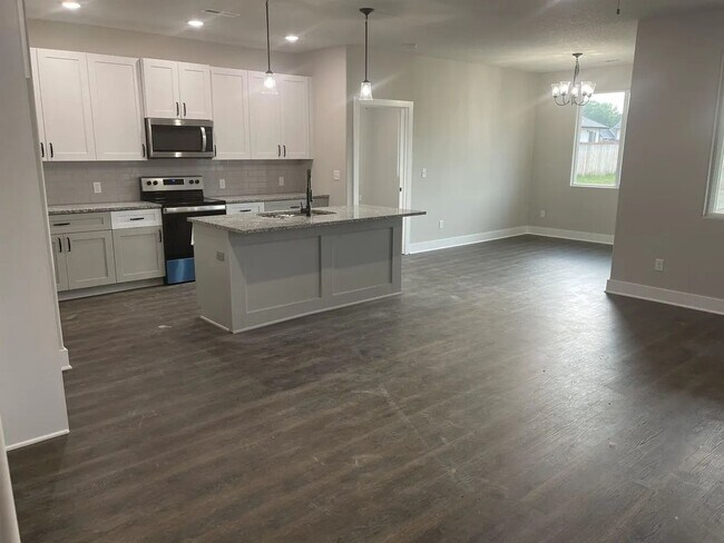 Building Photo - Single family slab home with three car garage. This home is 4 bedrooms, three bathrooms open floo...