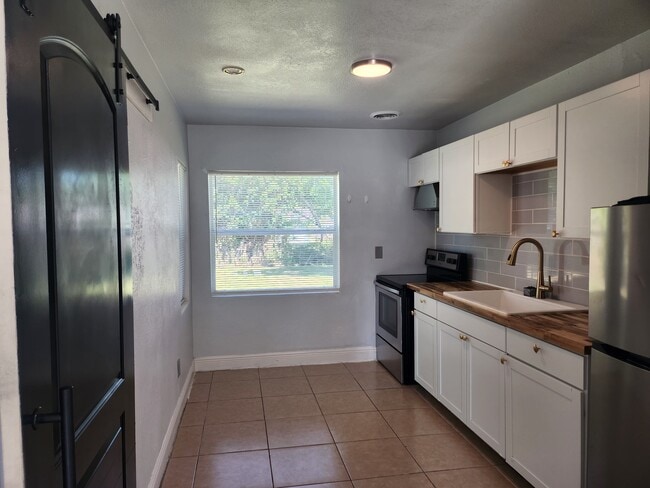 3rd bedroom behind black kitchen barn door - 1015 Woodland Ave