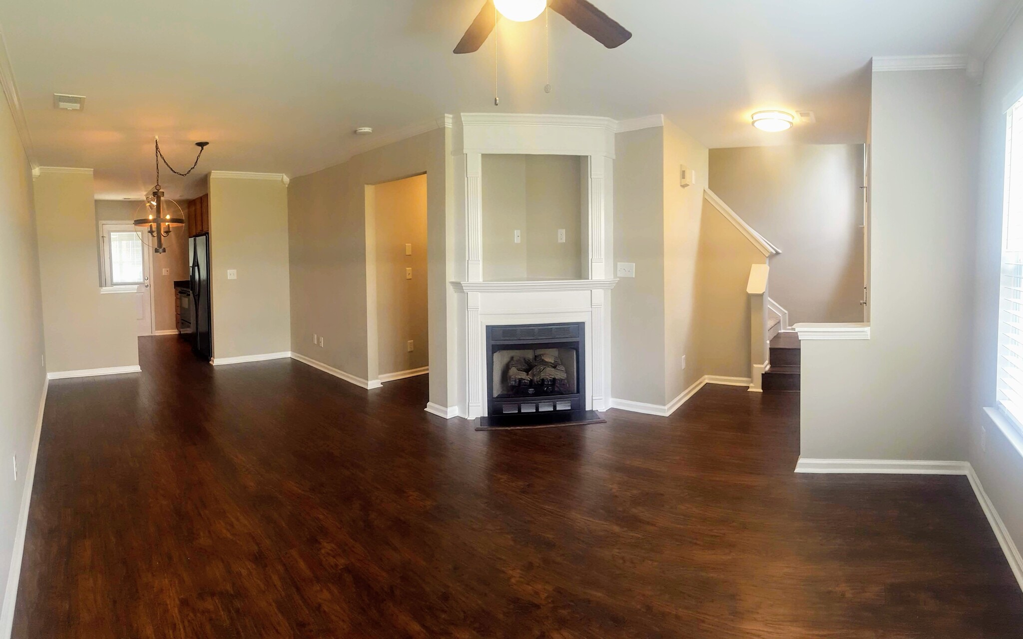 Open living area with gas fireplace for the cool fall evenings! Half bathroom, storage closet and access to the one-car garage also located downstairs. - 3377 Weston Street