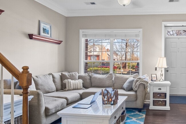 Building Photo - This inviting two-level townhome offers comfort and style, featuring gleaming hardwood floors on ...