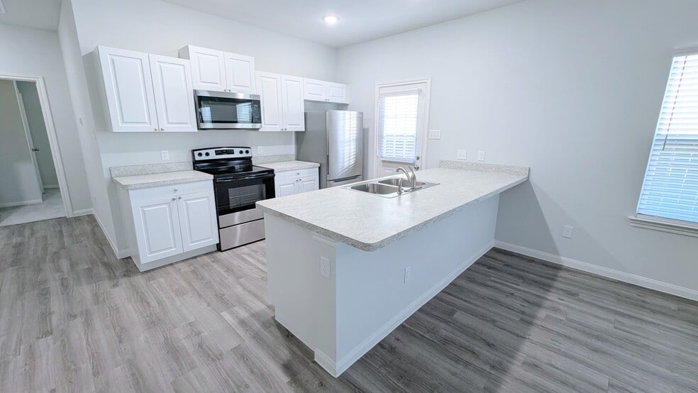 This large island peninsula easily fits four barstools. - 13218 HP Johnson St