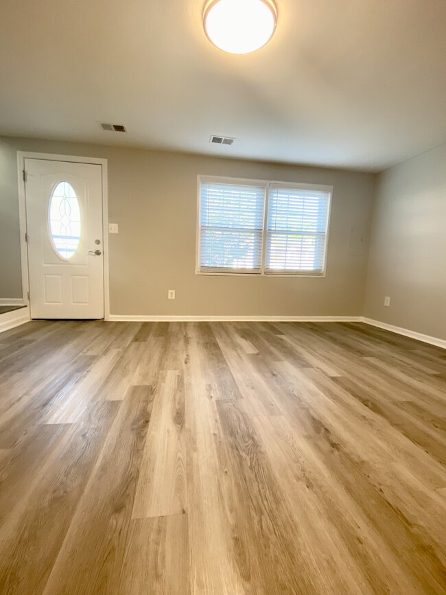 Open floor plan- living and dining area - 1861 Village Green Dr
