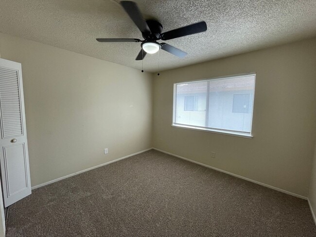 Building Photo - Two Story Fourplex Unit - On site Laundry, Carport, Ceiling Fans