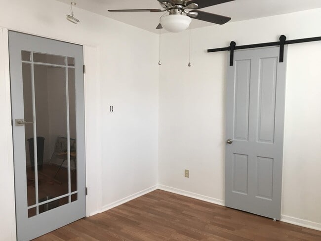 bedroom with barn door for closet - 4118 Mercury Ave