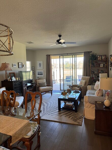 Living room to lanai. Please note a lot of the furniture has been removed to create more space. - 9645 SW 63rd Loop