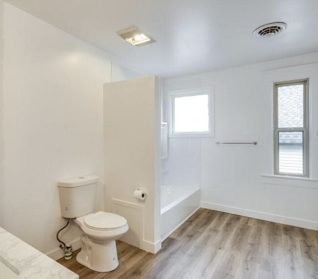 spacious bathroom with newly installed toilet and shower/tub combination - 3317 W 41st St