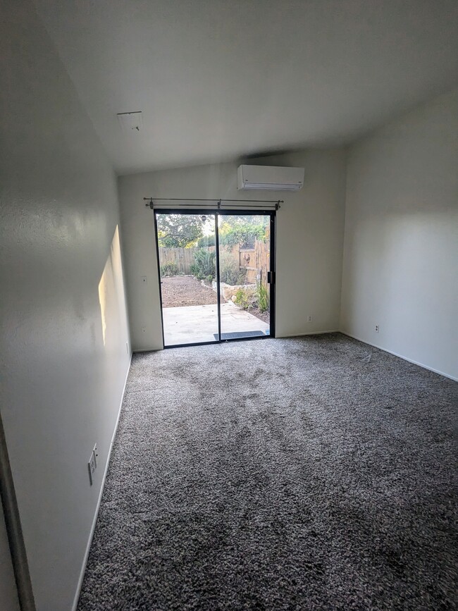 primary bedroom has high ceilings and a sliding door to the back yard - 4025 Via Diego