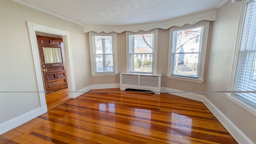 Bright and spacious living room with refinished hardwood floors and beautiful natural light - 37 Glover Ave