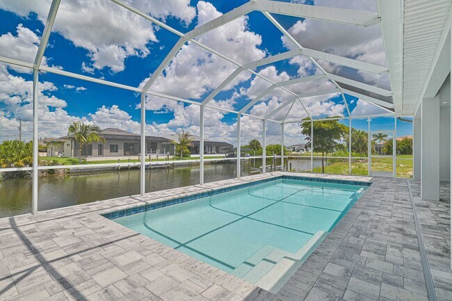 Building Photo - NOW AVAILABLE - Gorgeous Pool Home ~ NW Cape ~ 3 Car Garage ~ On Canal!