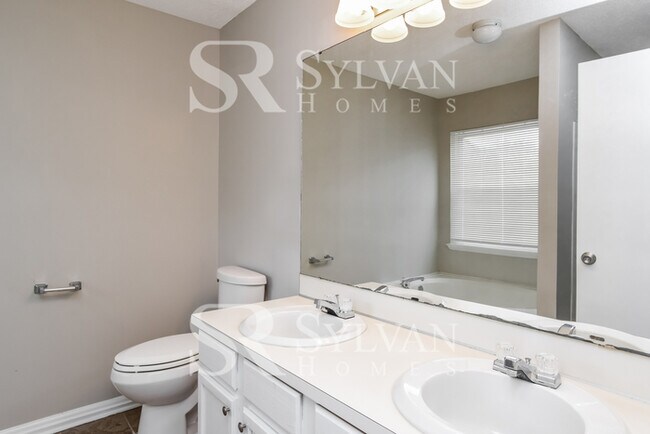 Building Photo - This home exudes a cheerful and welcoming charm!