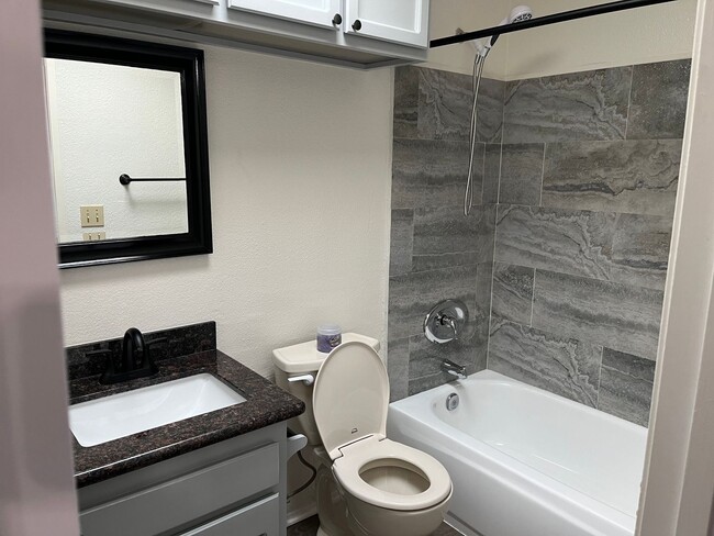 Building Photo - Cozy 2nd story apartment in the heart of City Heights.  Vaulted ceilings, fireplace, onsite laundry